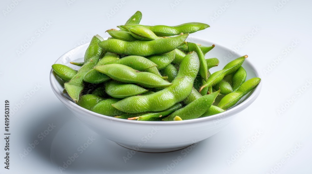 Fresh, vibrant green edamame pods are neatly arranged in a white bowl Fresh, vibrant green edamame pods are neatly arranged in a white bowl