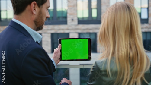 Obraz na płótnie Formal couple discussing mockup tablet at street closeup. Business team working w salonie