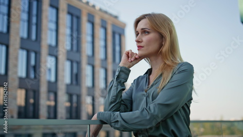 Pensive manager watching city view office district closeup. Woman thinking work