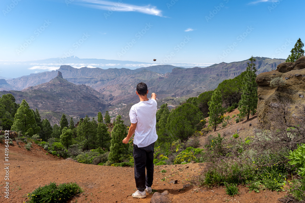 Fototapeta premium Young man hiking at the top of Gran Canaria Island in a sunny day. Canary islands. Spain