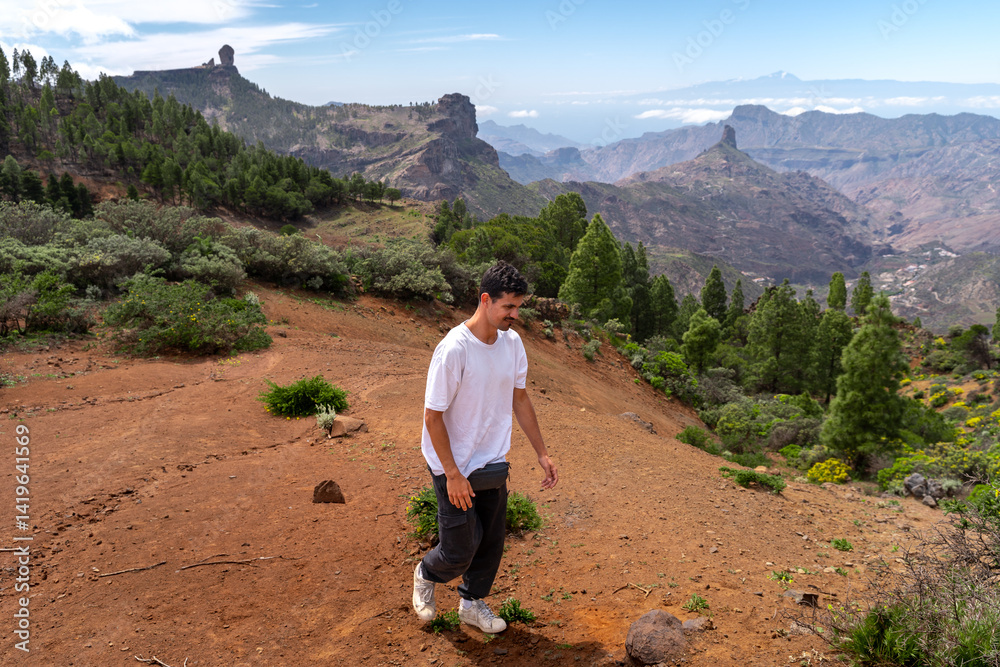 Young man hiking at the top of Gran Canaria Island in a sunny day. Canary islands. Spain Young man hiking at the top of Gran Canaria Island in a sunny day. Canary islands. Spain