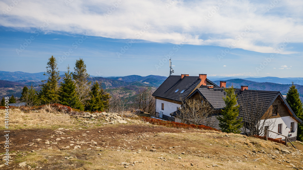 Mountain shelter on the top of Wielka Racza in the Żywiec Beskids. Beautiful mountain panorama. Early spring in the mountains.
