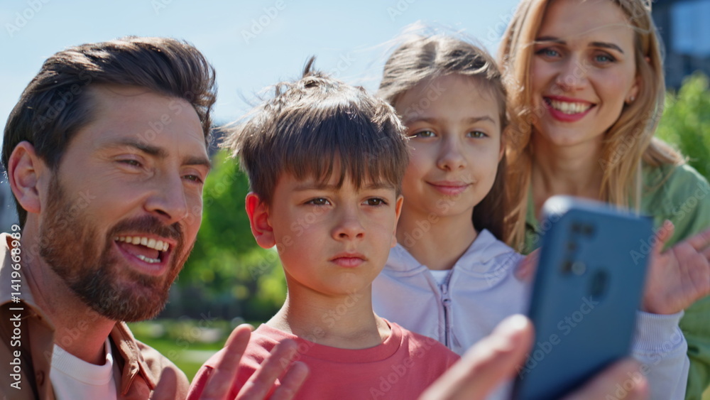 Cheerful relatives videocalling smartphone park portrait. Positive people online