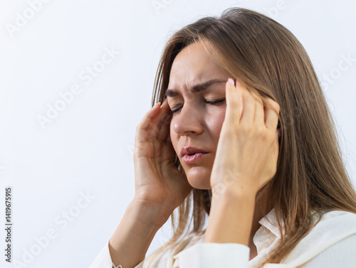 Stressed, Unhappy Young woman Suffering from Migraine, headache at home. Sick woman having headache feeling fatigue, anxiety and depression sits on sofa living room. mental health and health problem.