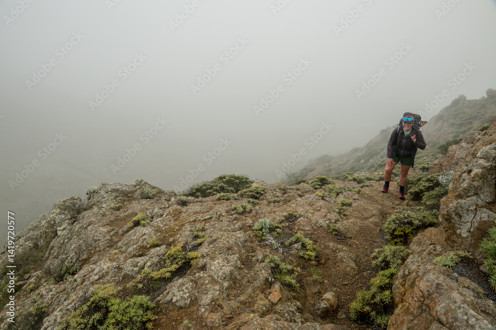 Woman Smiles While Climbing the Steep Montanon Ridge Trail
