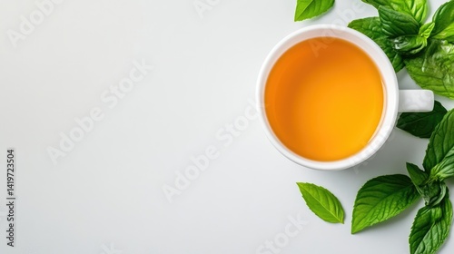 Wallpaper Mural A white ceramic cup filled with golden herbal tea, surrounded by fresh green mint leaves, minimalist composition on a light background, and serene and refreshing. Torontodigital.ca