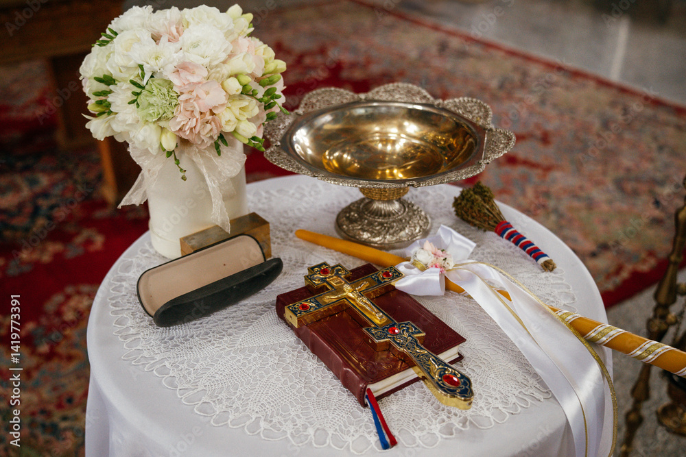 Novi Sad, Serbia - March 29, 2025: Accessories of a priest for Christian baptism. The text in the book is in Serbian