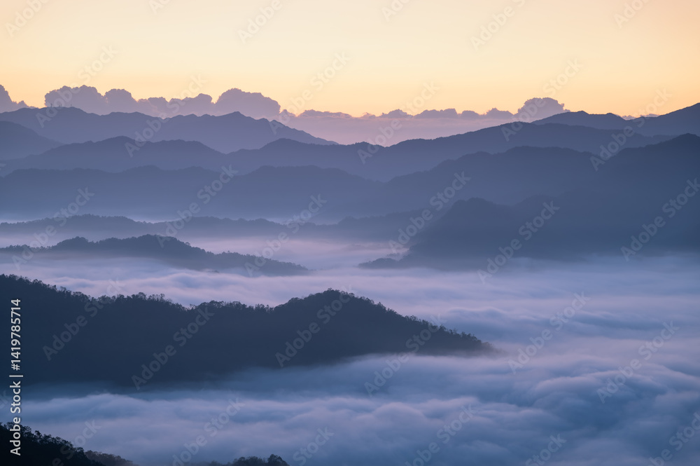 Obraz premium A serene morning view of clouds blanketing the mountain ridges in Xindian, Taiwan. Perfect for nature and landscape visuals.
