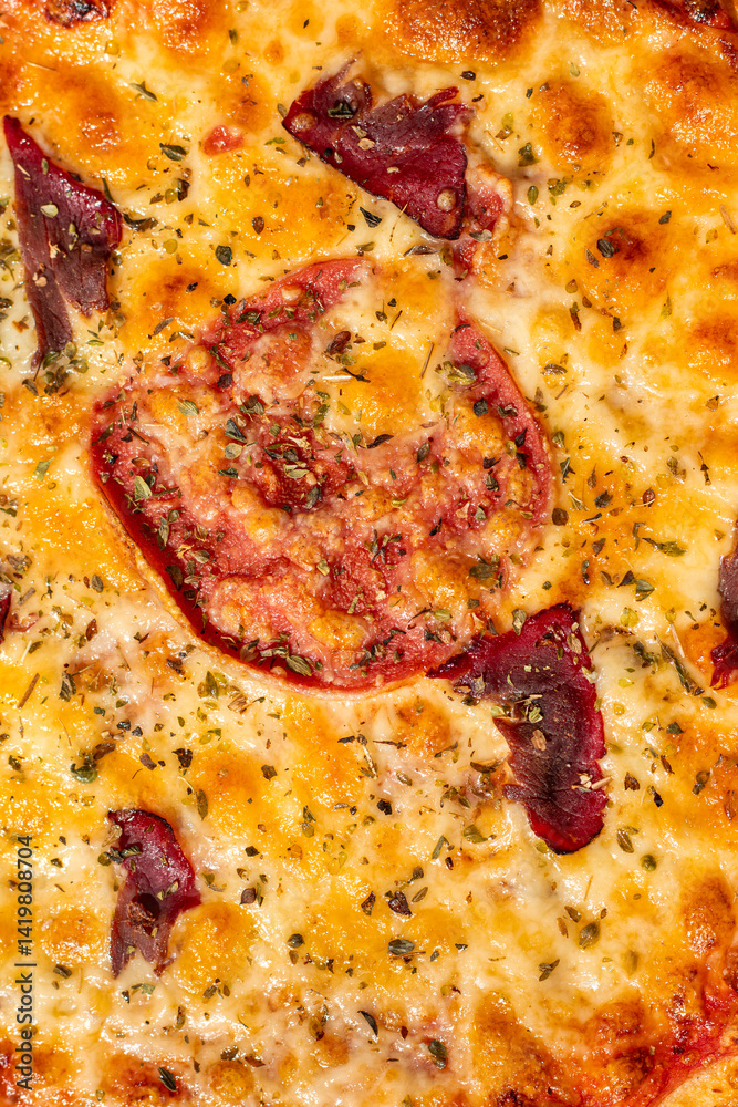 Pizza with mozzarella cheese, ham and sauce on plain grey background Pizza with mozzarella cheese, ham and sauce on plain grey background