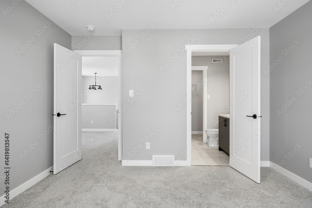 Large, empty room with a toilet and a sink Large, empty room with a toilet and a sink