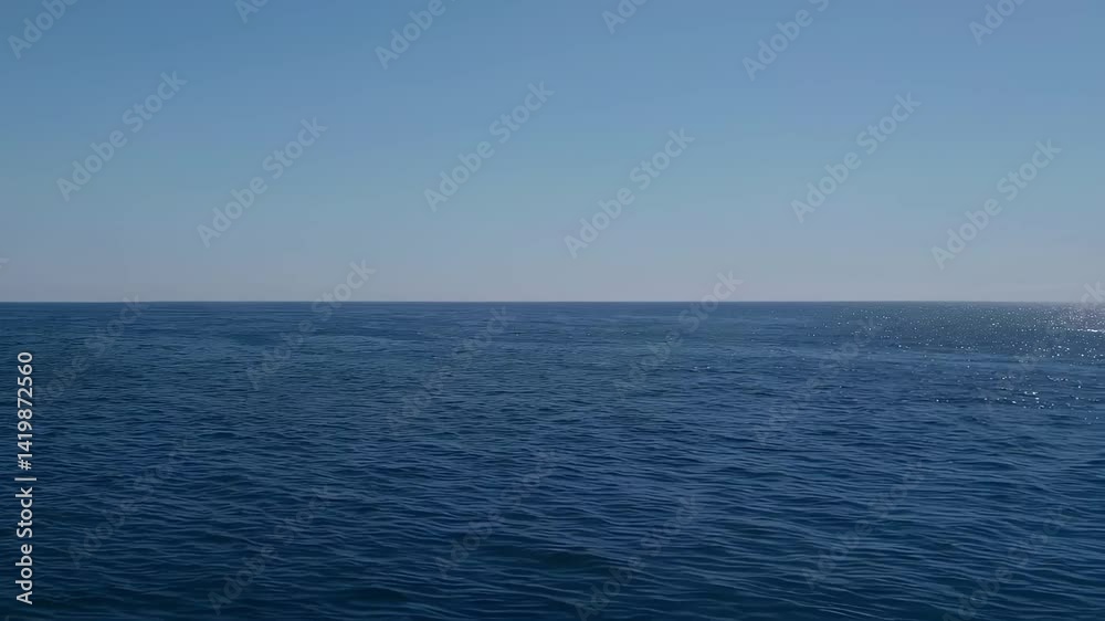 Tranquil Blue Ocean with Gentle Waves Under Clear Blue Sky Tranquil Blue Ocean with Gentle Waves Under Clear Blue Sky