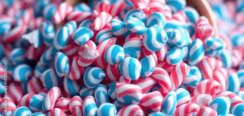 Overfilled bucket overflowing with blue and pink striped taffy candies, food, sweet treat