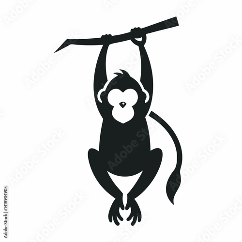 A playful baboon hanging upside down from a tree branch 