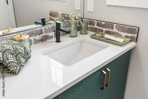Bathroom sink with a green cabinet and a white countertop
