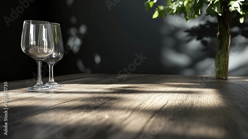 Empty wine glasses on a wooden table, sunlight