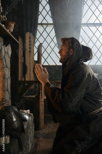 Solitary desperate priest kneeling before church altar in mystical smoke