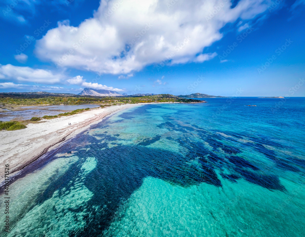 Aerial view of Lu Impostu beach under a huge cloud