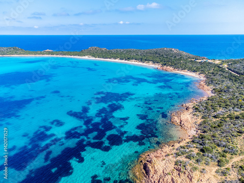 Drone view of Capo Coda Cavallo shore under a blue sky