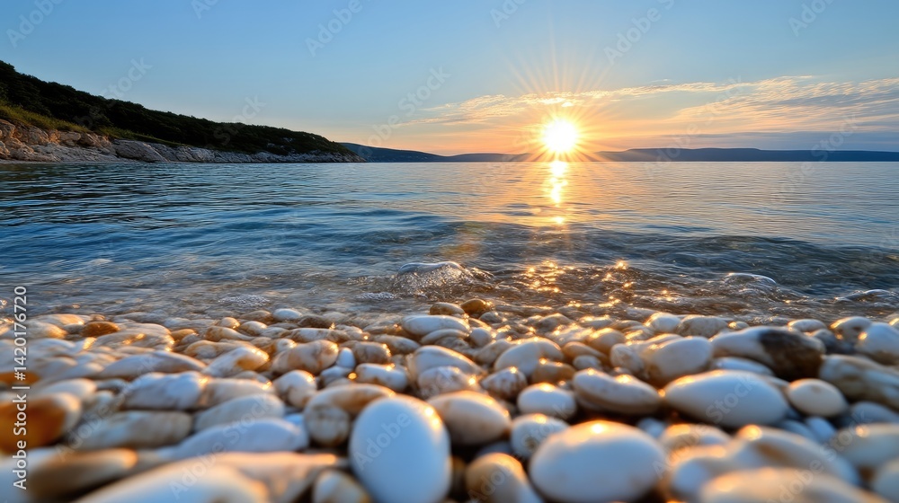 Obraz premium Sunrise over calm ocean shore, pebbles