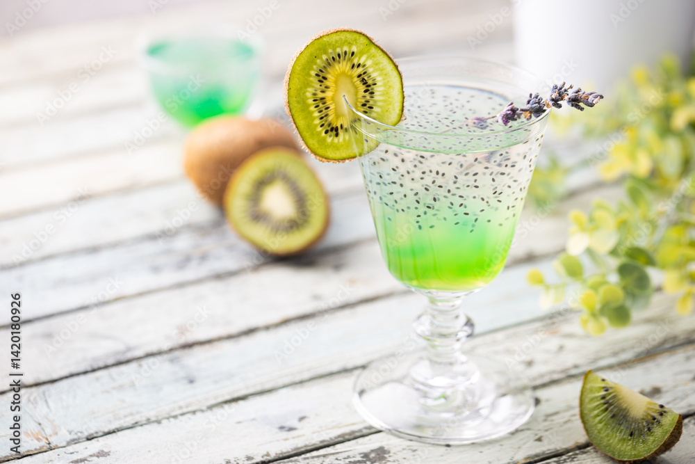 Cold cocktail kiwi drink in a glass with fresh fruits on white background