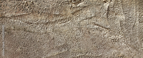 An old grey wall texture, background. Coarse concrete view. Ancient gray surface, backdrop. Rough, uneven surface in grey color with abstract pattern. An old concrete slab, weathered, faded with time