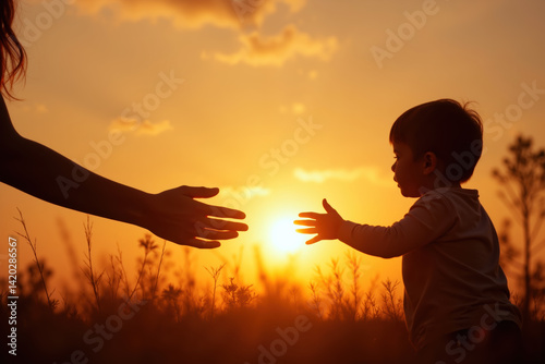 Obraz na płótnie A silhouette of a child reaching out to an adult's hand against a vibrant sunset, set in a grassy field. w salonie