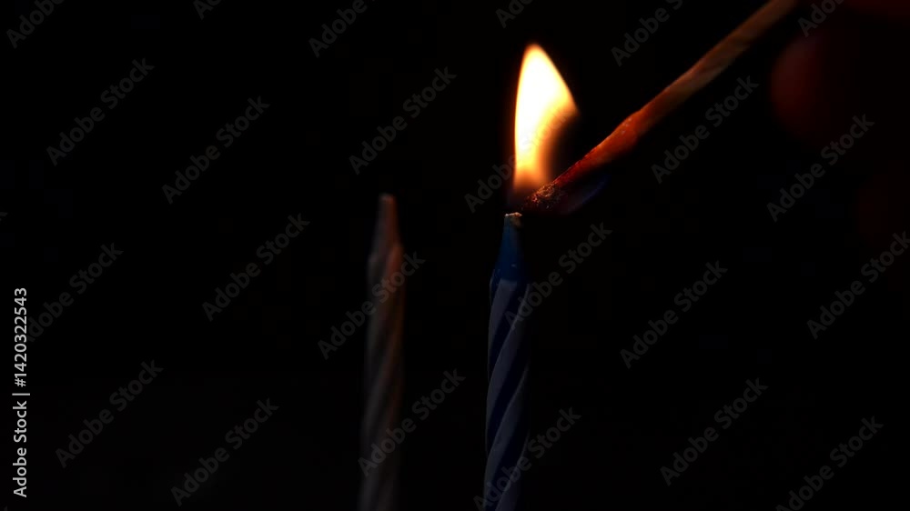 A matchstick lights a candle, enhancing the sense of warmth, peace, and tranquility. Birthday candles A matchstick lights a candle, enhancing the sense of warmth, peace, and tranquility. Birthday candles