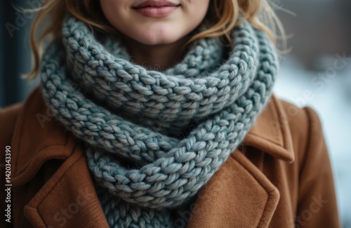 Obraz na płótnie Young woman in warm winter outfit wears blue knit scarf and brown coat. Seasonal apparel for cold weather fashion. Cozy, soft accessory for cold season autumn style. w salonie