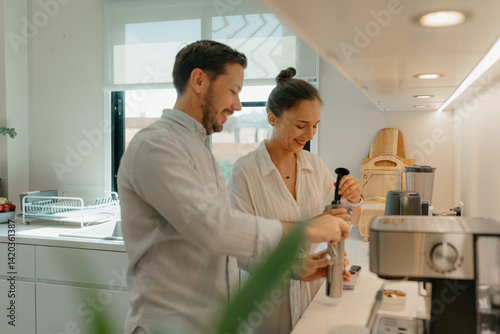 A couple is making coffee in the kitchen