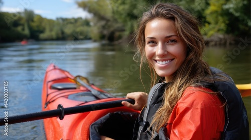 Smiling Woman Kayaking on River in Nature with Green Trees and Blue Sky in the Background