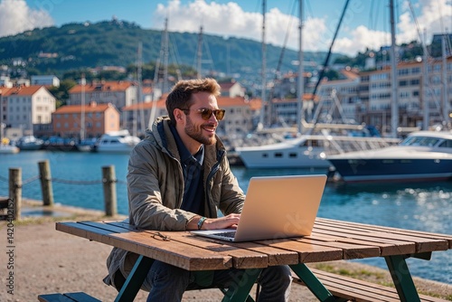 Obraz na płótnie Relaxed Digital Nomad Having a Sunny Day at a Harbor Picnic Table w salonie