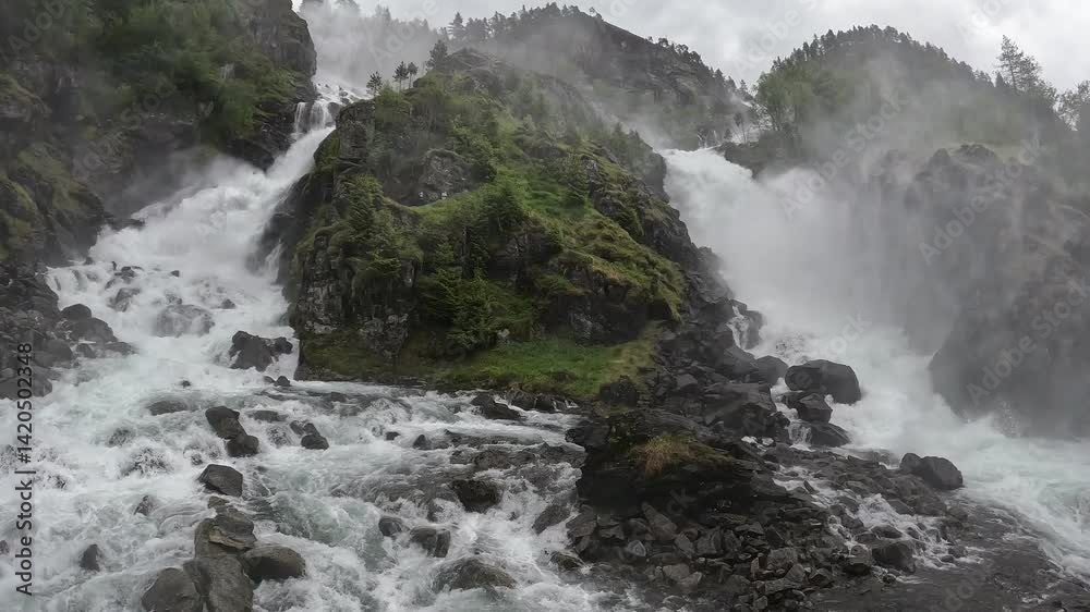 Scenic natural landscape of Latefossen Waterfall in Norway cascading down lush green cliffs