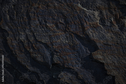 A textured stone background with chiaroscuro lighting, showcasing a brutal, monolithic rock formation. Cracks and fragments highlight its geological power, perfect for design templates or science