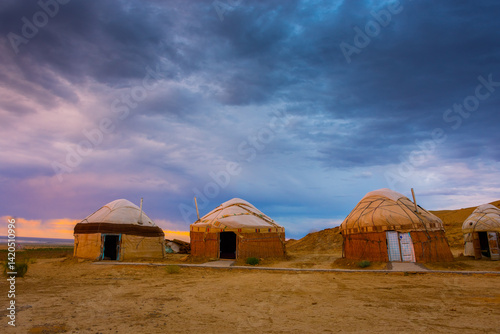 Obraz na płótnie Nomadic Yurt tent camp in the desert of the Aral Lake at sunset, Uzbekistan w salonie