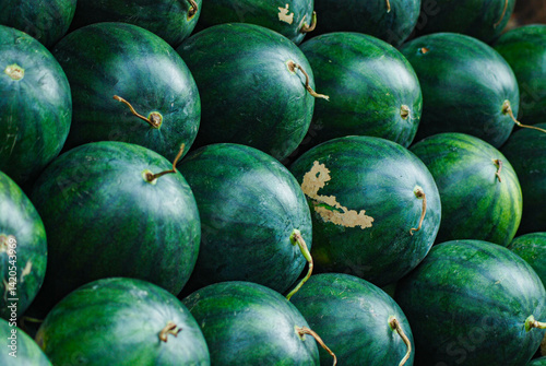 abstract background, close up view of pile of fresh green watermelons, traditional organic fruit market, healthy and hygienic