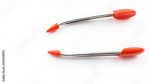 Close up of two metal and orange tipped tweezers isolated on a white background in a studio setting created with generated ai