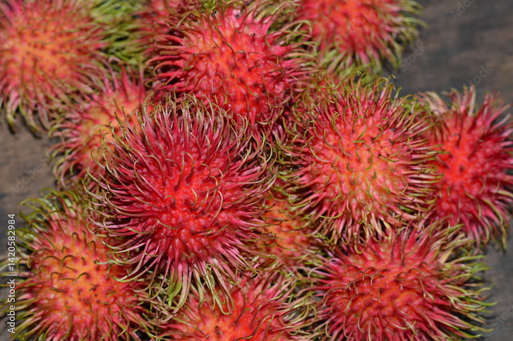 Fresh rambutan close up with vibrant red spiky skin and hairy texture. Great for tropical food, healthy living, blogs, ads, or Southeast Asian fruit themes. Fresh rambutan close up with vibrant red spiky skin and hairy texture. Great for tropical food, healthy living, blogs, ads, or Southeast Asian fruit themes.