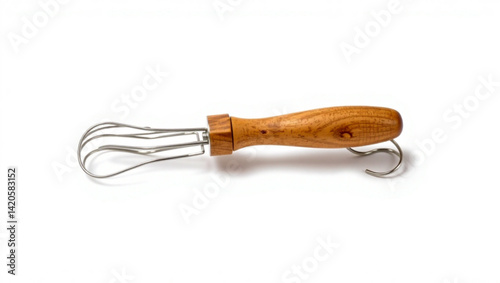 Close up of a metal whisk with a wooden handle lying horizontally on a white surface in a studio setting created with generated ai