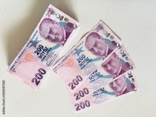 Fototapeta Naklejka Na Ścianę i Meble -  Turkish 200 Lira banknotes arranged on white background, emphasizing wealth and currency exchange