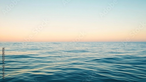 Expansive ocean horizon at pastel dawn.