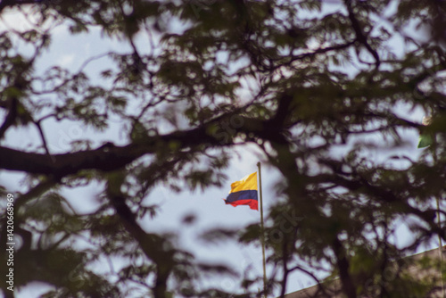 Colombia flag waving in a blue cloudy sky