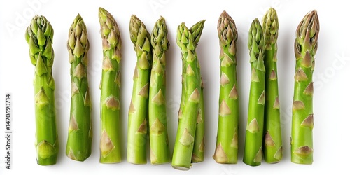 Obraz na płótnie Fresh green asparagus spears arranged on a clean white surface with natural lighting. w salonie