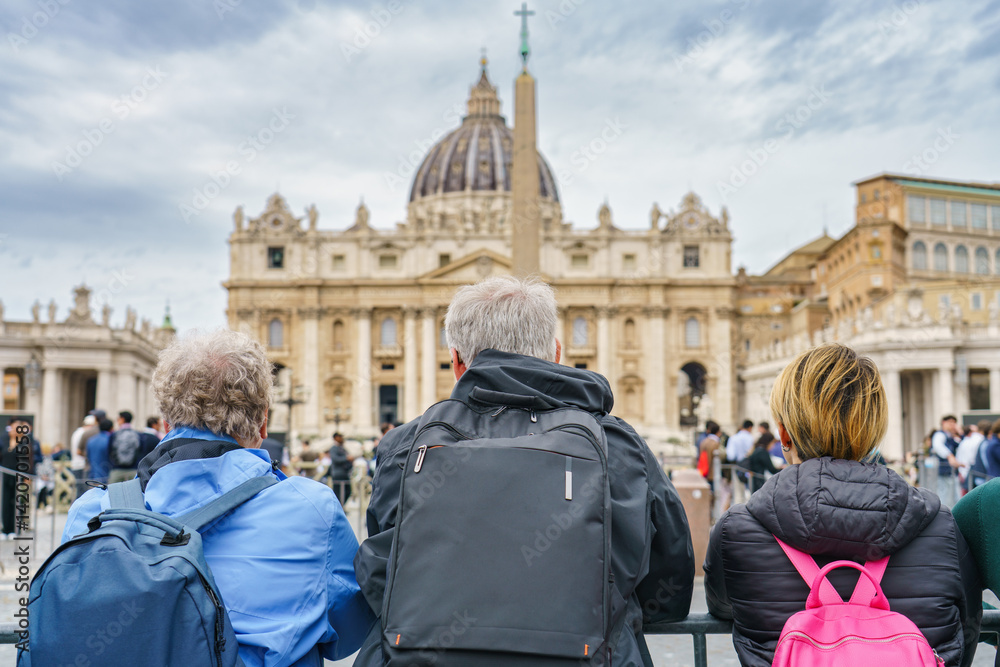 Tourists couple visit Vatican city and St. Peter's Basilica church in Rome. Italy