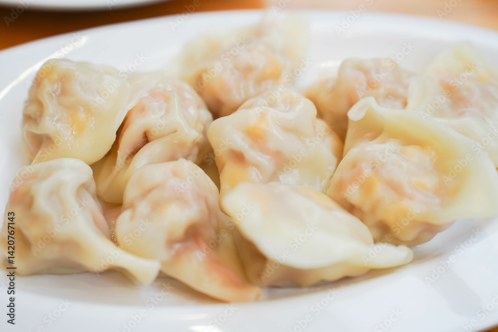 Close-up of a plate of dumplings on white plate, traditional Chinese snack