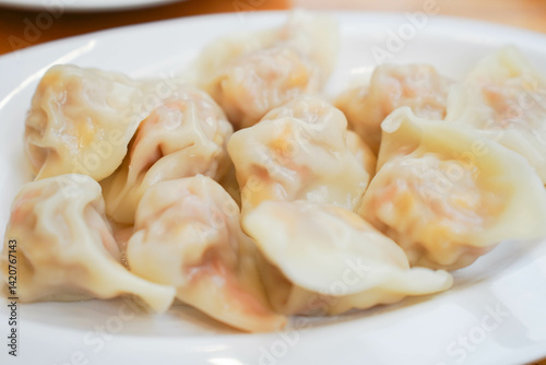 Obraz na płótnie Close-up of a plate of dumplings on white plate, traditional Chinese snack w salonie