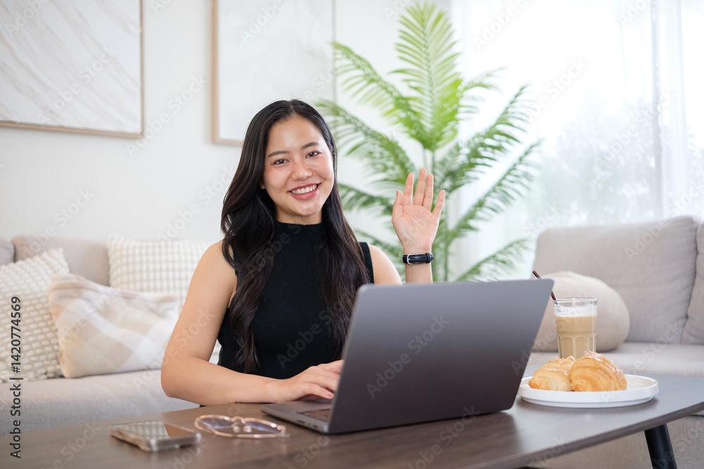 Young woman using laptop in the living room with coffee and croissant, enjoying a relaxed morning. Young woman using laptop in the living room with coffee and croissant, enjoying a relaxed morning.