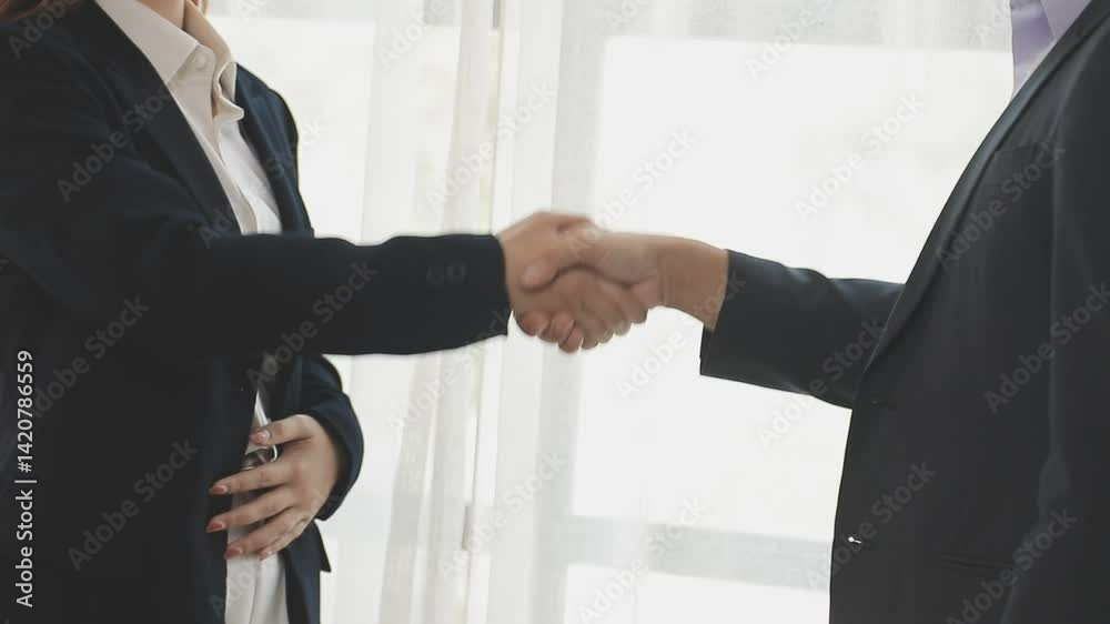 Hand shake business,Young business people shaking hands in the office. Finishing successful meeting. Three persons