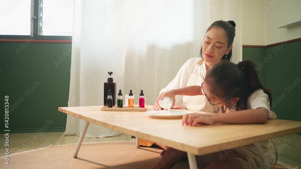 Mother and child doing a surface tension science experiment with milk and dish soap at home, learning through colorful and hands-on activity together.