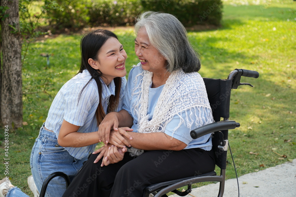 Two women, the daughter pushing a stroller with her elderly mother, walk in the garden and chat happily.