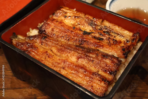 Unadon – Grilled Eel Over Steaming Rice, Glazed with Sweet Soy Sauce in Traditional Japanese Restaurant
